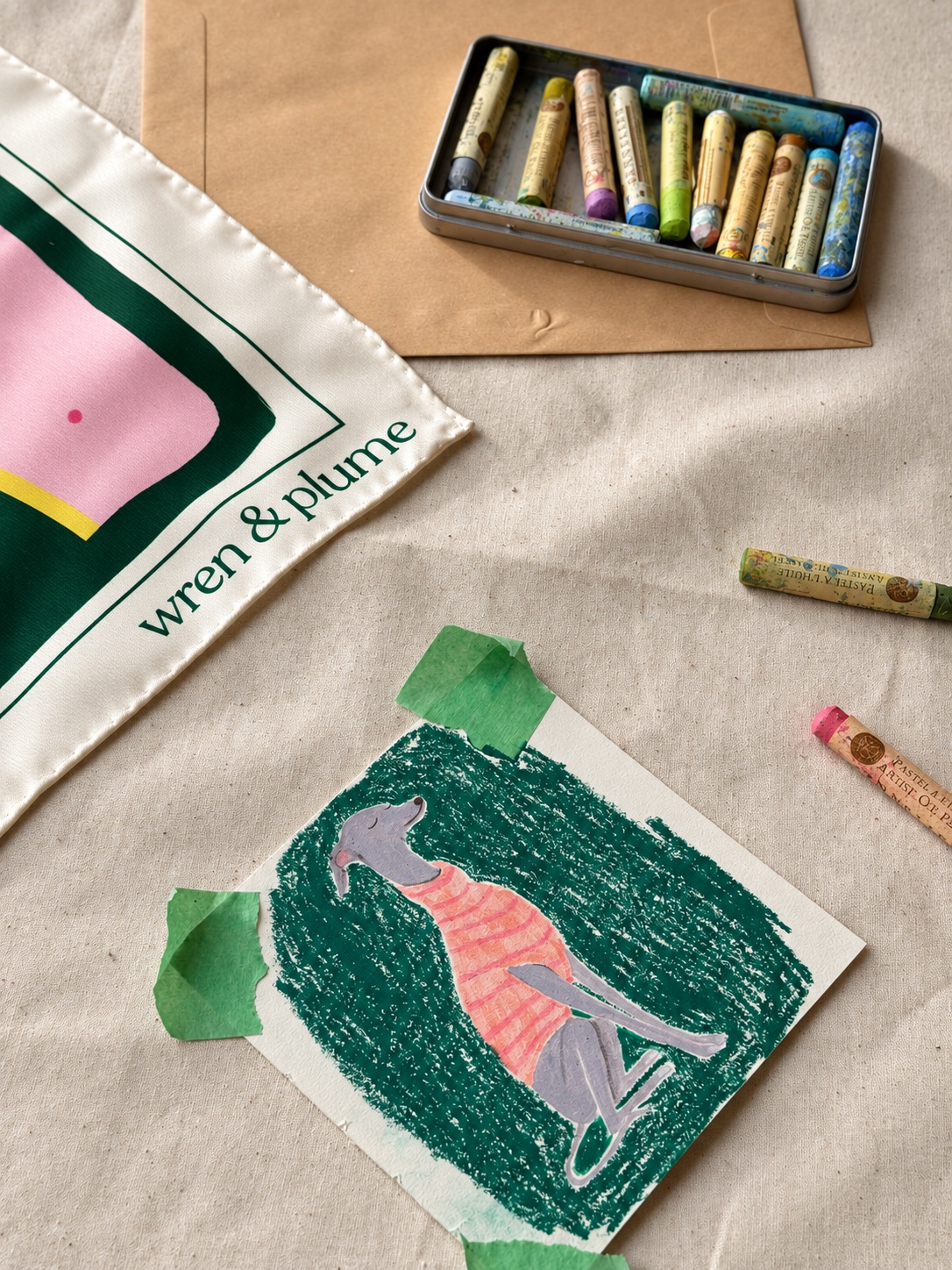 The artist’s greyhound drawing beside its pink and green silk scarf, with pastels on linen.